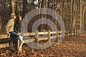 Young couple in the park at sunny autumn day