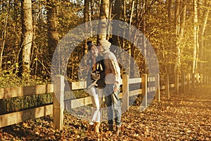 Young couple in the park at sunny autumn day