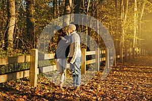 Young couple in the park at sunny autumn day