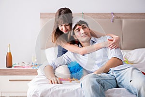 The young couple partying in the bed