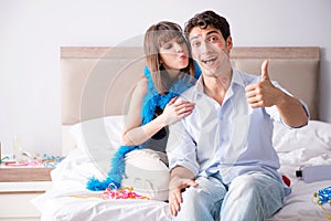 The young couple partying in the bed