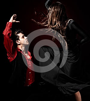 Young couple passion flamenco dancing on red ligh