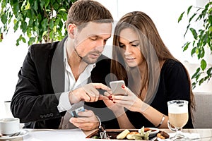 Young couple paying for ther order at the