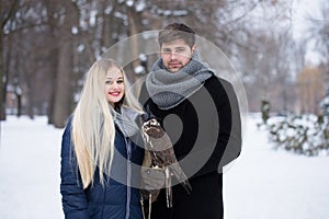 A young couple with a pet peregrine falcon