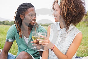 Young couple on a picnic drinking wine