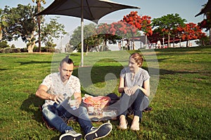 Young couple on a picnic in the park.