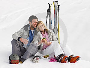 Young Couple With Picnic On Ski Vacation