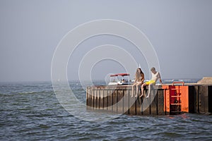 Young couple on a pier on Lake Michigan
