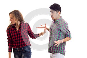 Young couple in plaid shirts arguing