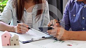 Young couple planning for comparison information on their decision to buy a new home together