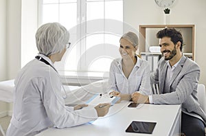 Young couple planning pregnancy and visiting professional medical specialist together