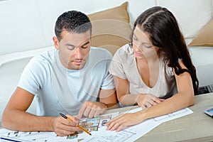 Young couple planning project their new home with blueprint