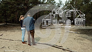 young couple planning their family dream house on purchased plot of land