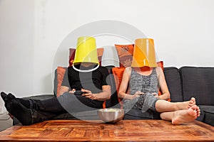 Young couple play video games sitting comfortably on the sofa at home