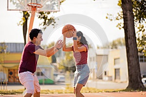 Young couple playing basketball