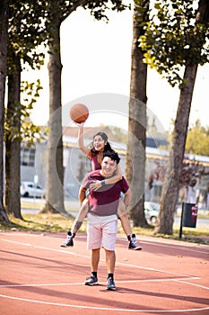 Young couple playing basketball