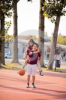 Young couple playing basketball