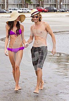 Young couple playing at the beach