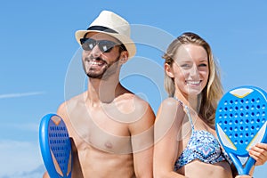 young couple playing beach tennis