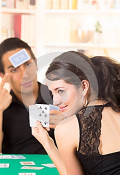 Young couple playing cards cuarenta