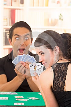 Young couple playing cards cuarenta photo