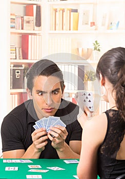 Young couple playing cards cuarenta photo