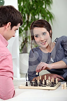 Young couple playing chess