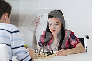 Young couple playing chess indoo