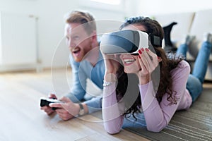 Young couple playing games with virtual reality headset