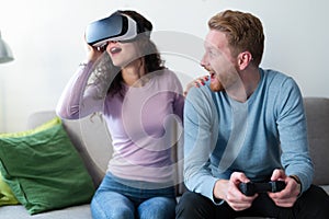 Young couple playing games with virtual reality headset