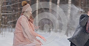 Young couple playing outdoors. Winter season.