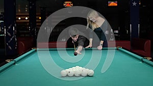 Young couple playing pool in entertainment center