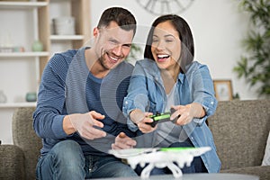 young couple playing video game together at home