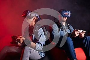 Young couple playing vr game isolated on black background