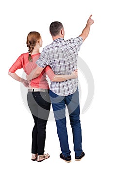 Young couple pointing.