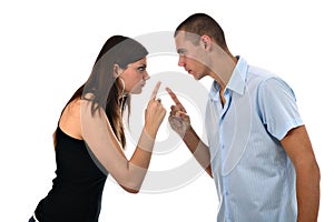 Young couple points fingers at each other isolated