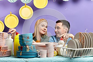 Young couple poiting at unwashed tablewear