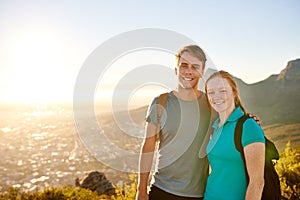 Young couple posing on a hike together with picturesque view
