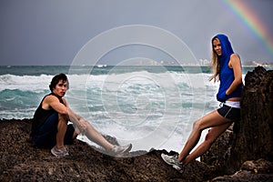 Young Couple Posing on Rocks By Stormy Ocean