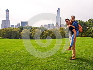 A young couple posing at Sheep Meadow in Central Park, NY, New York