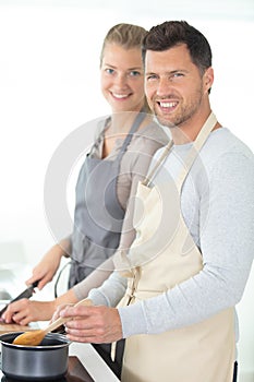 Young couple posing in their kitchen