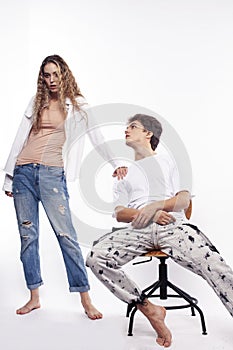 Young couple posing on white background isolated, fighting, arguing, unhappy people concept