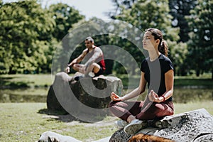 Young couple practicing meditation and mindfulness in serene urban park