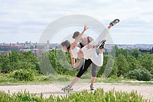 Young couple practicing street dance at a park wearing protective face masks