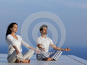 Young couple practicing yoga