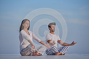 Young couple practicing yoga