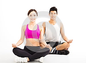 Young couple practicing yoga isolated on white