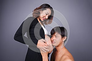 Young couple: pregnant mother and happy father on gray backgroun