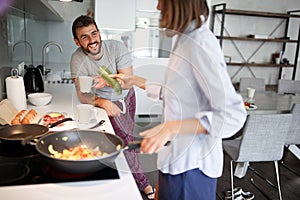 Young couple preparing food, drinking coffee in kitchen while talking and smiling. healthy food, lifestyle concept