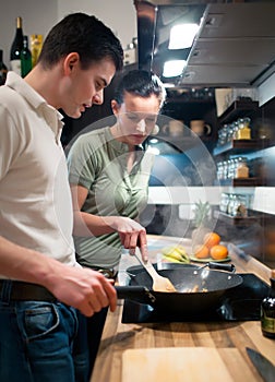 Young couple preparing lunch in kitchen